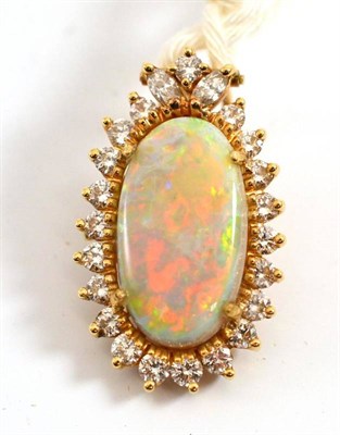 Lot 206 - An opal and diamond pendant, the oval cabochon opal within a border of twenty-one round...