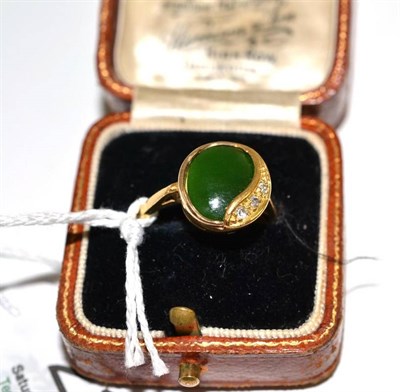 Lot 218 - An 18ct gold nephrite and diamond ring, the polished oval nephrite in a yellow collet setting, with