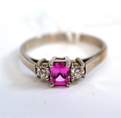 Lot 232 - An 18ct white gold pink sapphire and diamond three stone ring, the radiant cut pink sapphire...