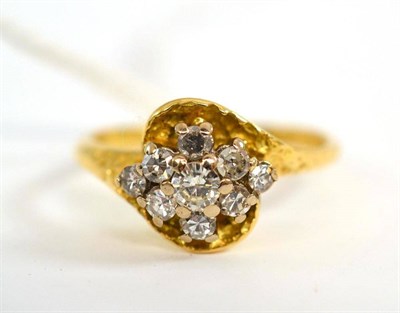 Lot 233 - An 18ct gold diamond cluster ring, set with a round brilliant cut diamond and eight-cut diamonds in