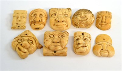 Lot 236 - A collection of nine Japanese ivory carvings of Noh masks, Meiji period