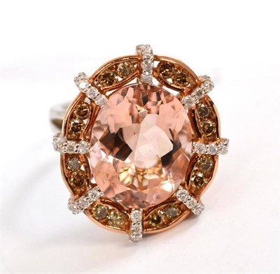 Lot 242 - A morganite and diamond ring, the oval cut morganite within a fancy border of white and tinted...