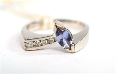 Lot 257 - A 9ct white gold tanzanite and diamond ring, with a marquise cut tanzanite and graduated round...