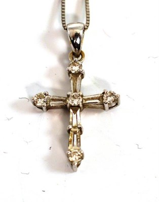 Lot 258 - A diamond cross pendant on chain, round brilliant cut and tapered baguette cut diamonds in...