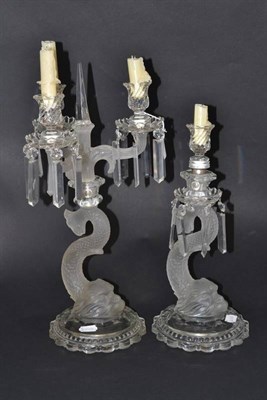 Lot 264 - A Baccarat style pressed glass dolphin candelabrum, 49cm high and a similar candlestick (2)