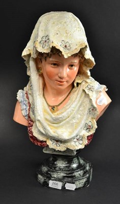 Lot 266 - A Continental pottery bust of a girl wearing a lace head scarf, 52cm high