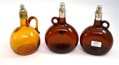 Lot 275 - Two brown glass bottles with silver mounts inscribed Brandy, Whisky and an amber glass example (3)