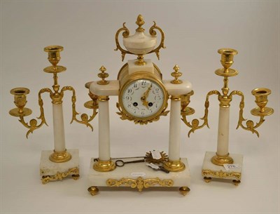 Lot 278 - A gilt metal mounted striking mantel clock with garniture, urn finial, enamel dial, twin barrel...