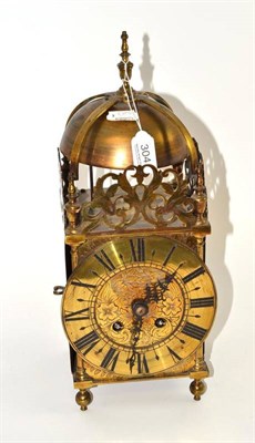 Lot 304 - A brass striking lantern clock, early 20th century, twin barrel movement striking on a top...