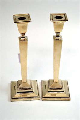 Lot 305 - A pair of Queen Elizabeth II loaded silver candlesticks, Birmingham 1961, 26cm high