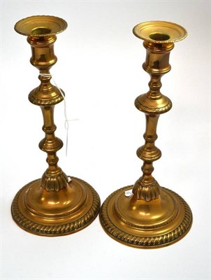 Lot 309 - # Pair of George III brass candlesticks, shouldered knopped stems, ogee domed bases with...