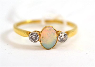 Lot 370 - An opal and diamond three stone ring, the oval cabochon opal in a yellow millegrain setting,...