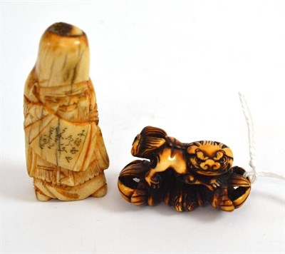 Lot 373 - A Japanese carved ivory shishi/vajra netsuke circa 1900 and a bone netsuke as Jurojin circa...