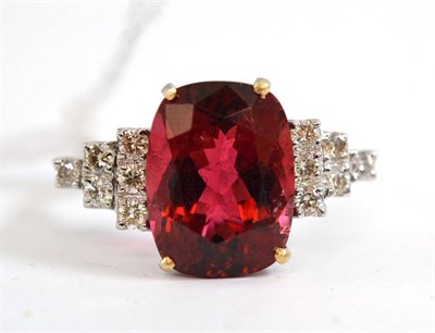 Lot 385 - An 18ct white gold tourmaline and diamond ring, the cushion cut tourmaline flanked by six round...