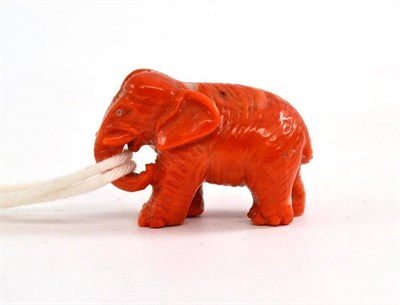 Lot 408 - A Chinese carved red coral standing figure of an elephant, late 19th century, in trumpeting...