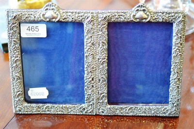 Lot 465 - An Edwardian silver double photograph frame, Birmingham 1901, 26cm wide