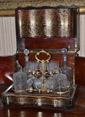 Lot 471 - A second Empire premier-partie scarlet boulle drinks cabinet, decorated with arabesque foliage, the