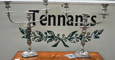 Lot 484 - A pair of Old Sheffield Plate candelabra, each with rectangular bases with reeded decoration...