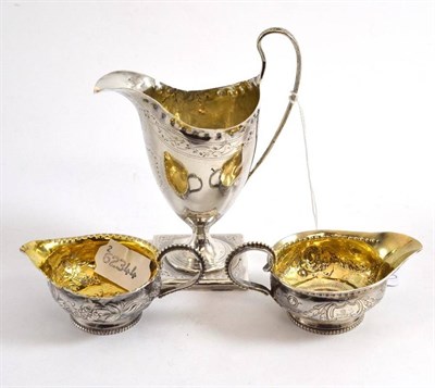 Lot 545 - A George III silver cream helmet, London 1792, also two other George III jugs, one inset with a...