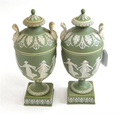 Lot 554 - A pair of Wedgwood green jasper pedestal vases and covers, 24cm high