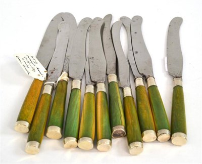 Lot 576 - A set of eleven 18th century knives circa 1750, with stained green ivory handles and steel...