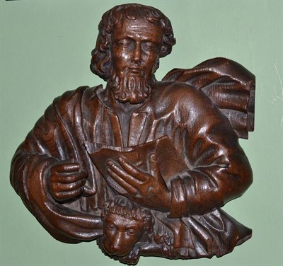 Lot 602 - # An 18th century German carved oak panel, the apostle Mark holding an open book, with the...