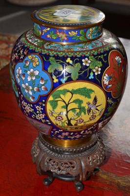 Lot 622 - A Chinese cloisonné ginger jar on a foliate carved stand, overall height 31cm