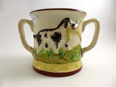 Lot 626 - A 19th century Staffordshire pottery frog loving cup moulding with dogs and game, 14cm high