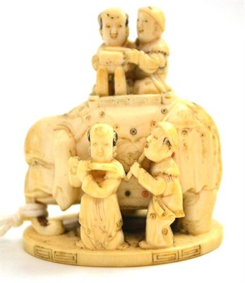 Lot 638 - A Japanese carved elephant ivory okimono, Meiji period (1868-1912), as an elephant and five...