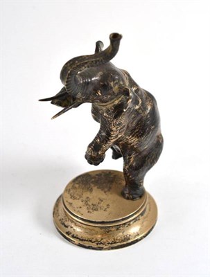 Lot 640 - A Russian silvered metal dancing elephant table lighter, early 20th century, standing on its...