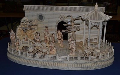 Lot 651 - A Chinese ivory veneered diorama, early 20th century, the oval base set with carved figures and...