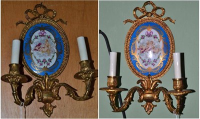 Lot 662 - A pair of gilt metal and porcelain mounted wall sconces