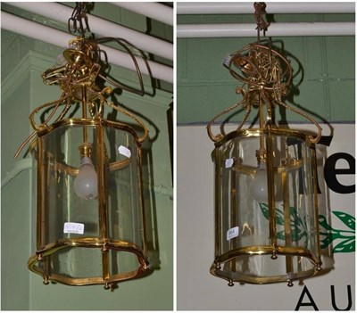 Lot 664 - ^ Pair of brass hanging lanterns fitted for electricity, 51cm high