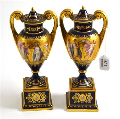 Lot 671 - Pair of Vienna blue ground and gilt decorated vases with covers, 26cm high