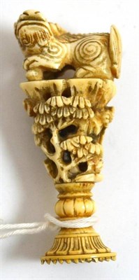 Lot 696 - A Chinese ivory seal, 19th century, as a Dog of Fo on a stem of flowering trees and branches,...