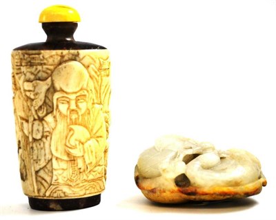 Lot 697 - A Chinese carved ivory snuff bottle and a small jade carving