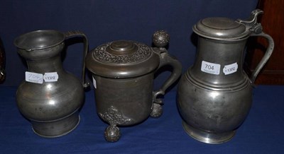 Lot 704 - An 18th century pewter flagon and hinged cover, 28cm high With a baluster pewter measure with...