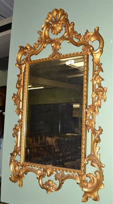 Lot 731 - A 20th century carved giltwood and gesso wall mirror in the Georgian style, with shell and...