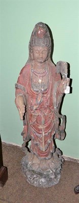 Lot 733 - A 19th century carved and painted wood figure of Guanyin, depicted holding a fly whisk and...