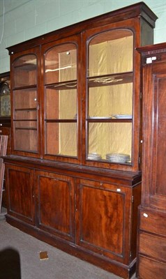 Lot 735 - Victorian mahogany triple door bookcase, the upper section with glazed doors, the base with...