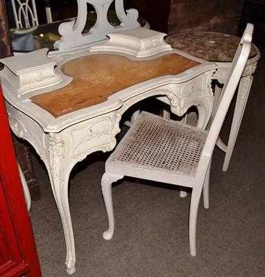 Lot 757 - A cream painted serpentine shaped writing table on cabriole legs, a circular two tier...