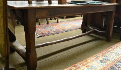 Lot 778 - A joined oak farmhouse kitchen table, the cleated top above a single frieze drawer, raised on...