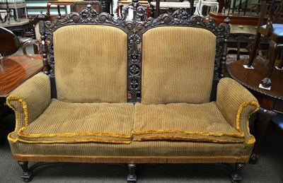 Lot 789 - A 17th century style carved walnut settee, late 19th century, upholstered in brown cord fabric,...