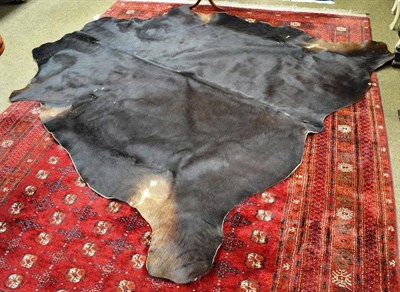 Lot 790 - A cow skin rug, 210cm long