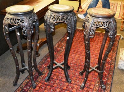 Lot 798 - A pair of Chinese carved hardwood and pink marble plant stands, early 20th century, of circular...