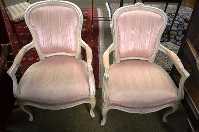 Lot 810 - Pair of cream painted French style open armchairs upholstered in pink silk