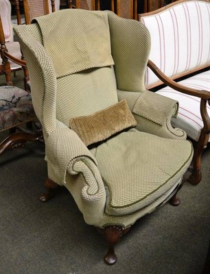 Lot 812 - Walnut wing armchair in olive check fabric with squab cushion