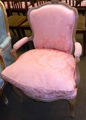 Lot 830 - # Louis XV style limed beechwood fauteuil with carved cresting upholstered in pink cotton brocade