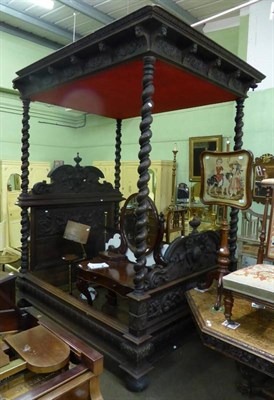 Lot 872 - Victorian carved walnut four poster bed of large proportions, the canopy with figural carved masks