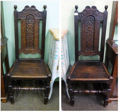 Lot 878 - Pair of early 18th century carved oak hall chairs